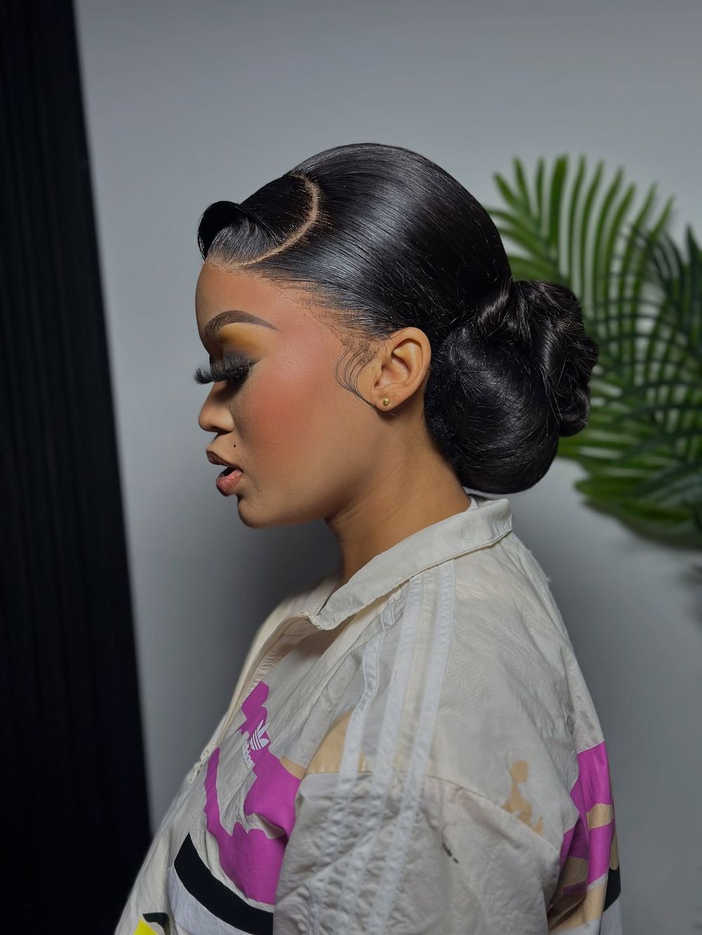 Sleek side-part bun in profile